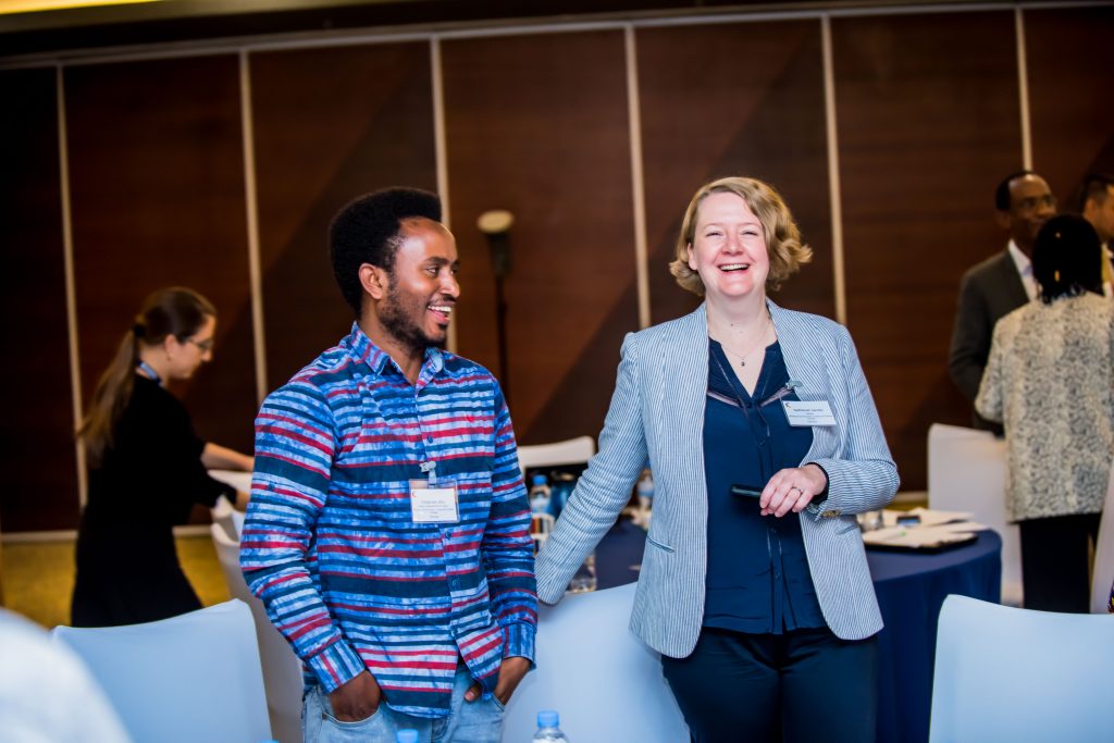 Two people standing up and laughing